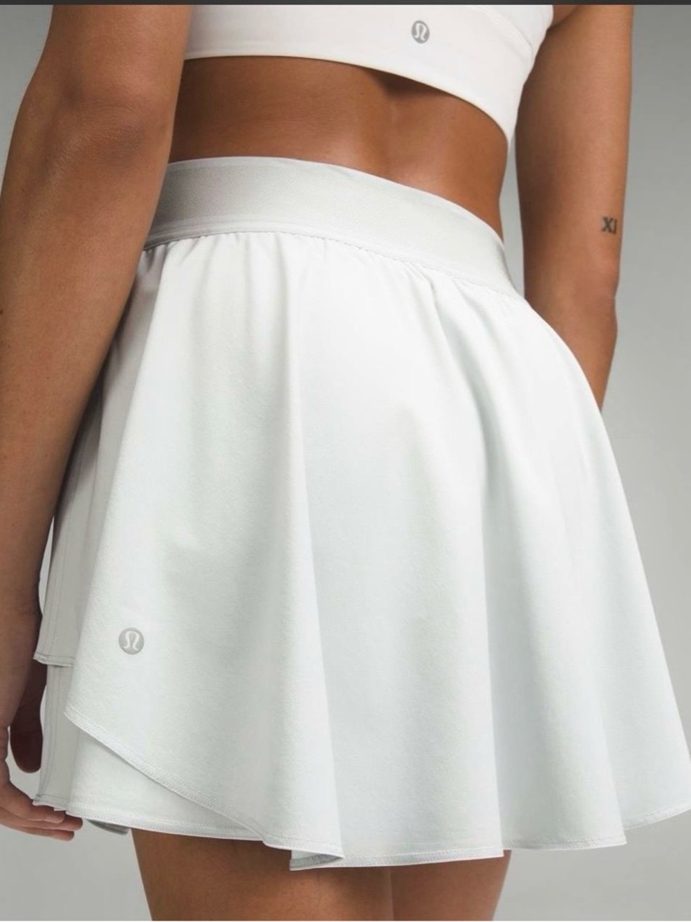 Lululemon Court Rival High Rise Skirt in white, featuring a flowy layered design
